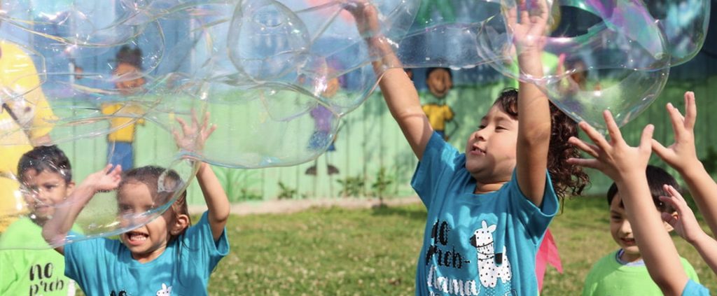 happy kids playing with soap bubbles.