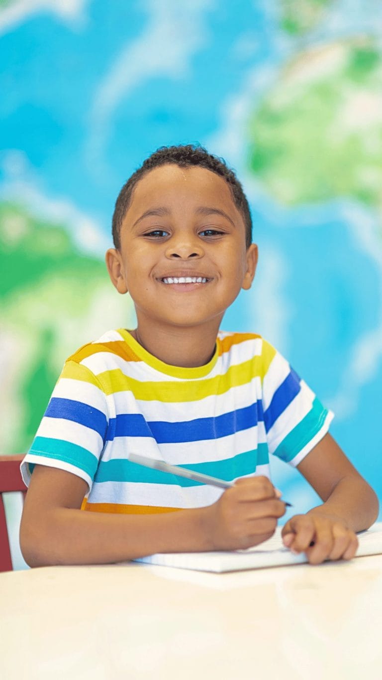 Young student writing at a table